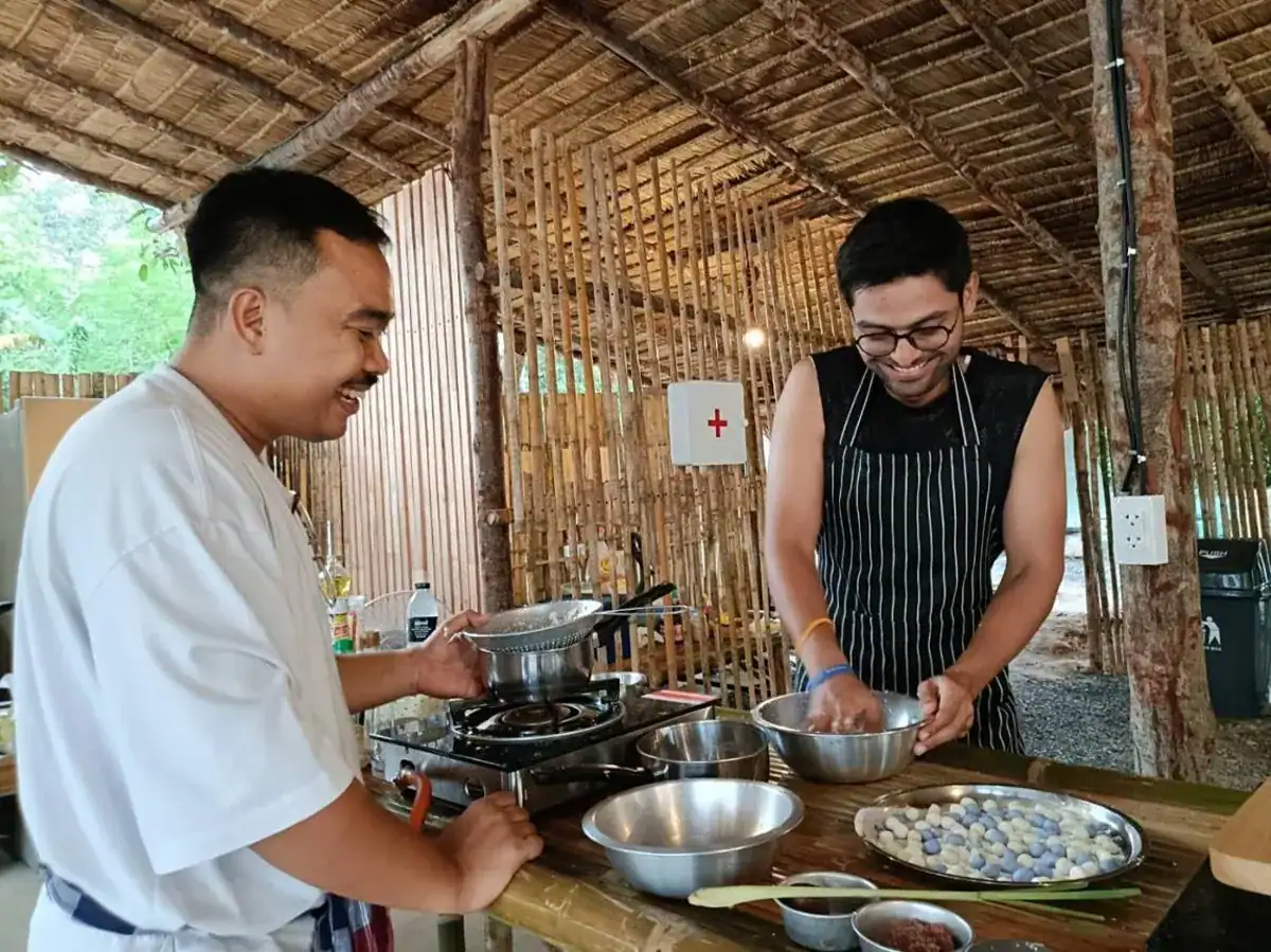 Guests cooking popular Thai dishes during a private cooking class in Phuket