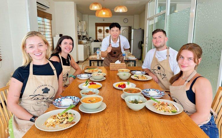 Guests enjoying a private Thai cooking class in Phuket with hands-on instruction