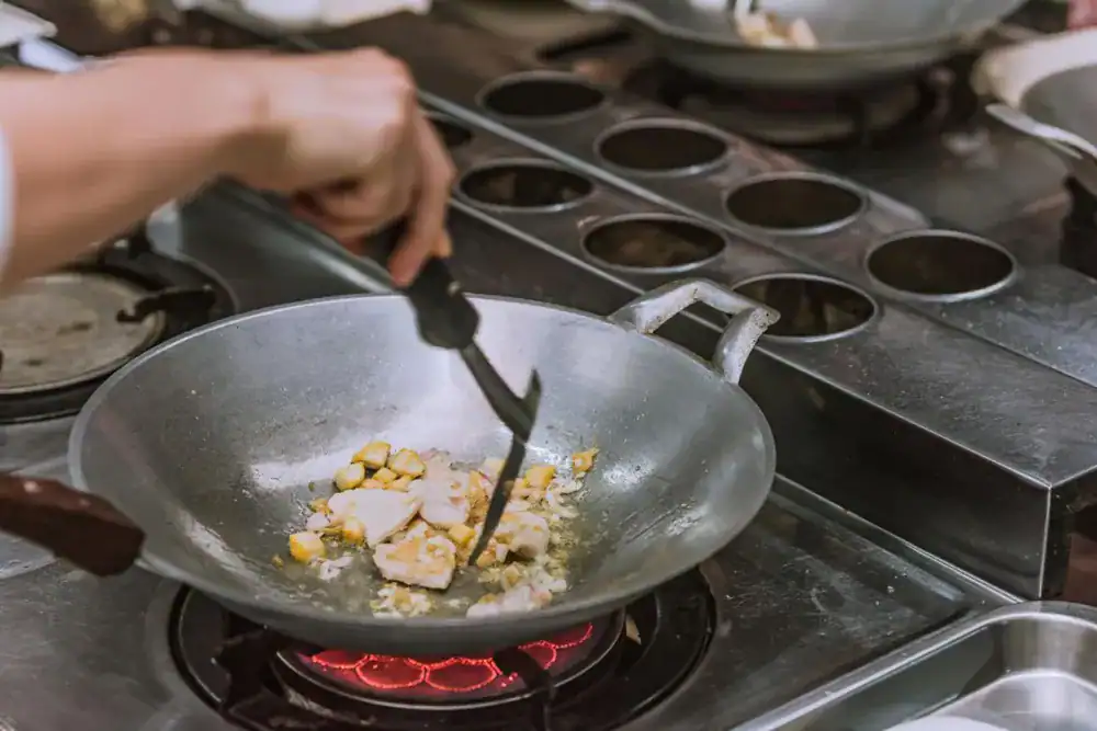 Hands-on Thai cooking experience preparing dishes in a Phuket kitchen